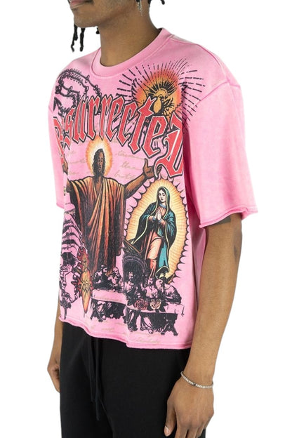 On Time Fashions pink heavyweight French terry tee featuring a graphic Jesus Relic print and raw hem detail.