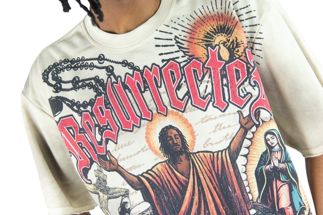 On Time Fashions Rebel Minds Jesus Relic cream heavyweight French terry graphic tee with religious artwork.
