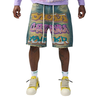 On Time Fashions vintage blue denim shorts with rhinestone graffiti graphic, drawstring waist, and raw cutoff hem.