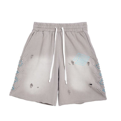 On Time Fashions grey terry cloth shorts with rhinestone detailing on the sides and distressed details.