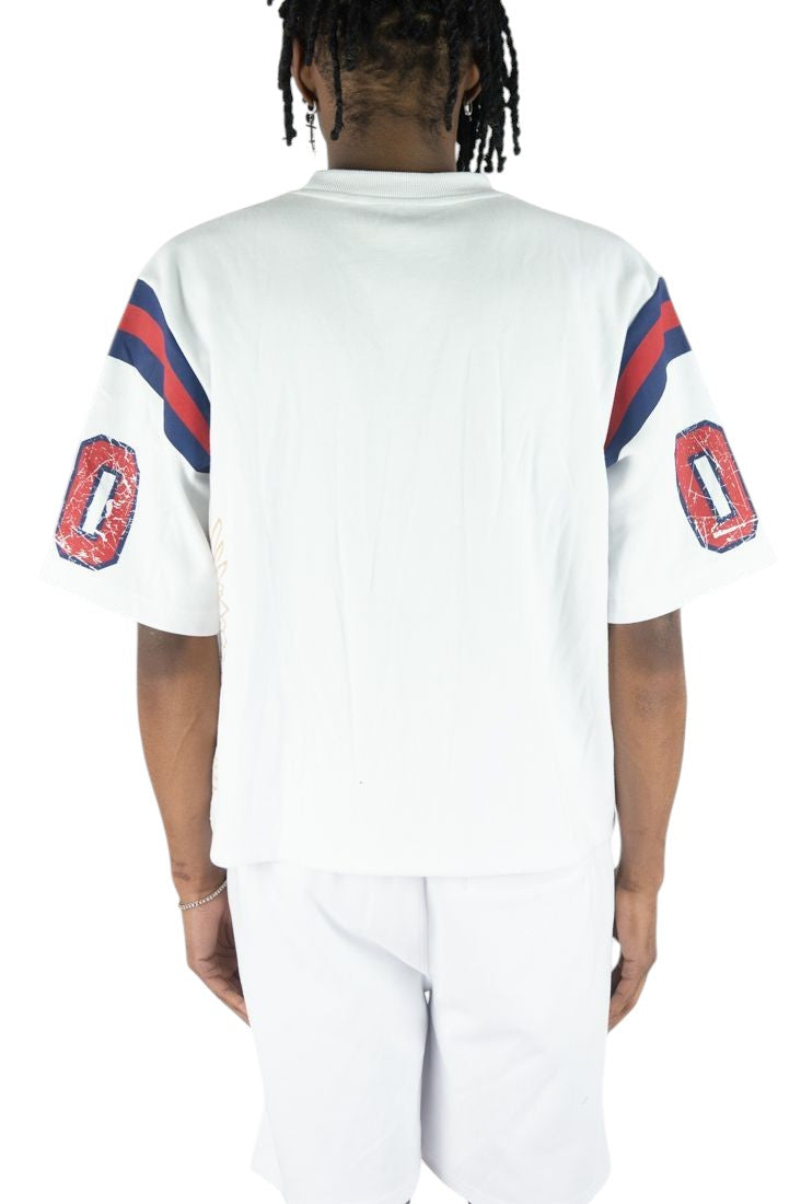 On Time Fashions white jersey with red and blue striped sleeves and distressed '0' graphics. Relaxed fit.