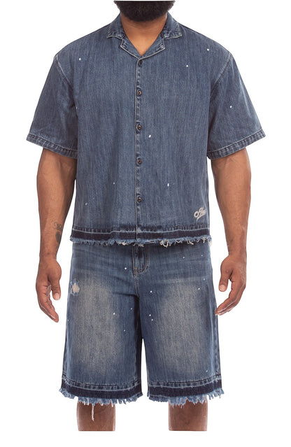 On Time Fashions men's blue denim shorts with paint splatter, distressed details, and frayed hem.