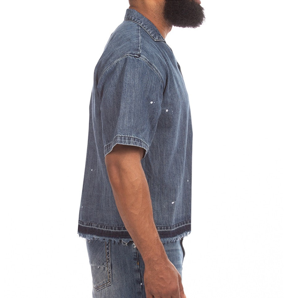 On Time Fashions Akoo SS Woven short sleeve denim shirt with paint splatter and raw frayed hem.
