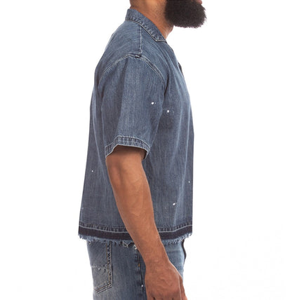 On Time Fashions Akoo SS Woven short sleeve denim shirt with paint splatter and raw frayed hem.