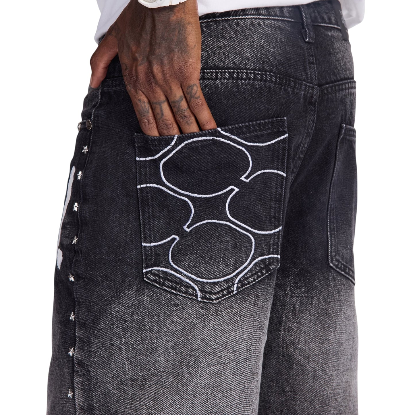 On Time Fashions black denim Dallas Jorts with graphic pocket detail and star embellishments on the side.