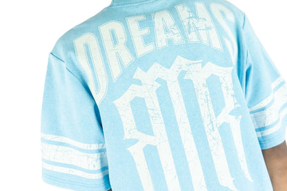 On Time Fashions light blue cotton jersey with distressed white 'DREAMS' graphic and striped sleeves.