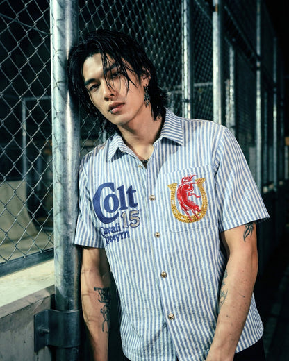 On Time Fashions blue and white striped short-sleeve button-up shirt with 'Colt 15' embroidery and a horseshoe with a bull graphic.