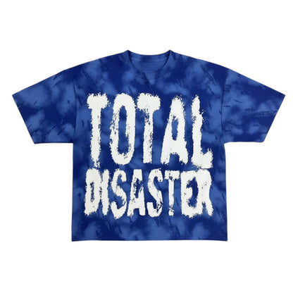 On Time Fashions Saint Cropped Tee, a blue tie-dye t-shirt with white "TOTAL DISASTER" graphic.