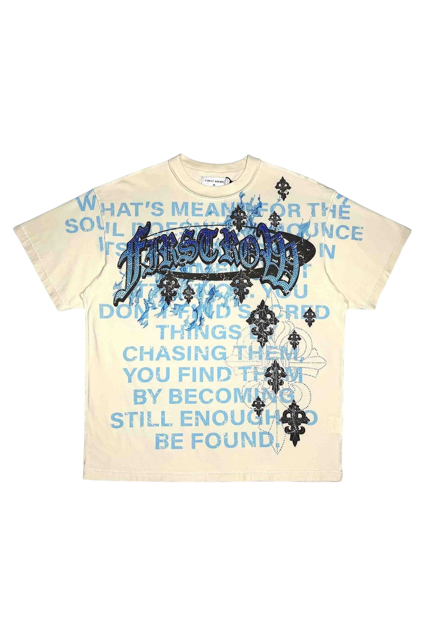 On Time Fashions cream 100% cotton relaxed fit tee with blue text graphic and rhinestone detailing.
