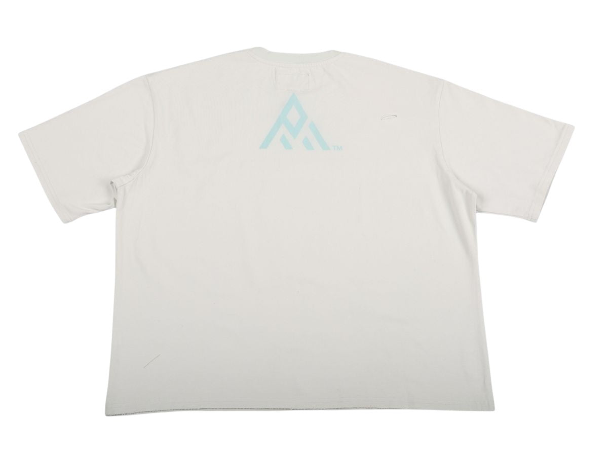 On Time Fashions Paper Money Love Letter Tee, a light grey short-sleeve t-shirt with a pale blue abstract logo on the back.