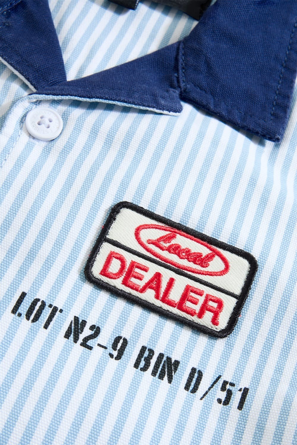 On Time Fashions Jordan Craig Kids Local Art Dealer Camp Shirt in blue and white Bengal Stripe with navy collar and embroidered patch.