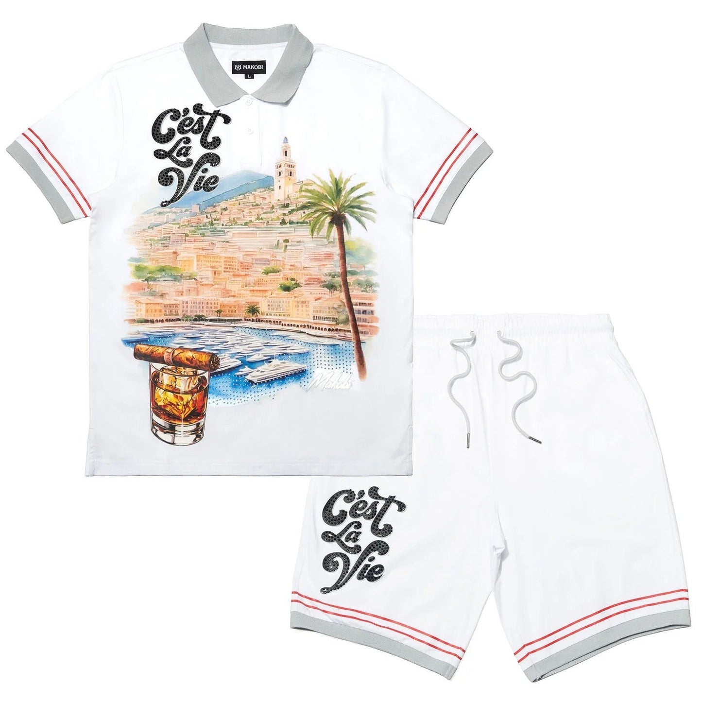On Time Fashions Makobi white polo shirt and shorts set with a scenic coastal print, palm tree, cigar, and "C'est La Vie" rhinestone graphic.