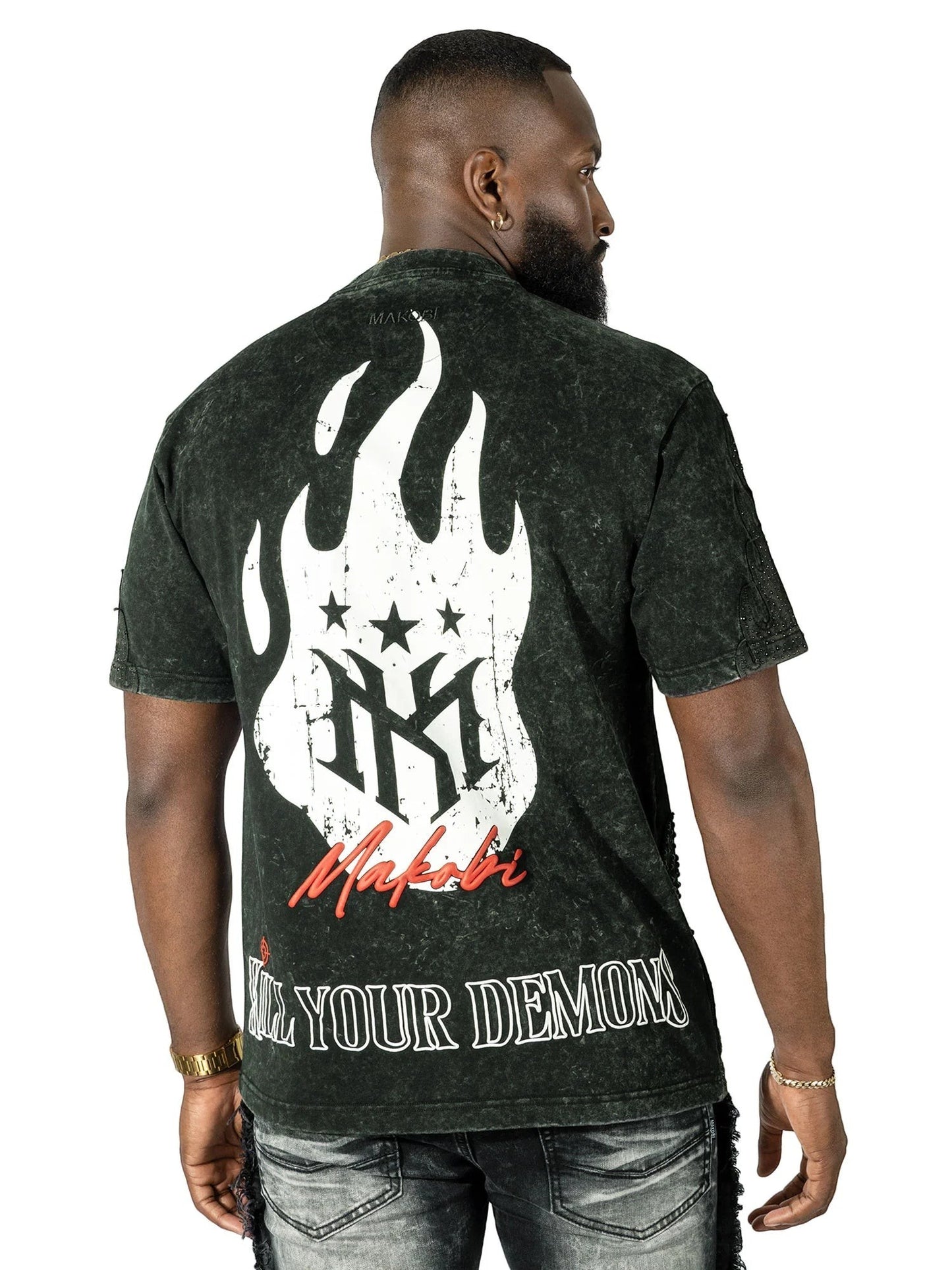 On Time Fashions Makobi Tesoro Tee, a dark wash, distressed cotton t-shirt with a graphic print of white flames, stars, and the Makobi logo on the back. Text reads "KILL YOUR DEMONS".