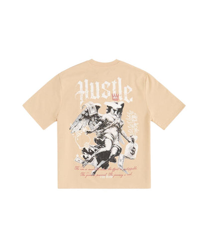 On Time Fashions tan heavy terry t-shirt with 'Hustle' graphic and angel holding money bags.