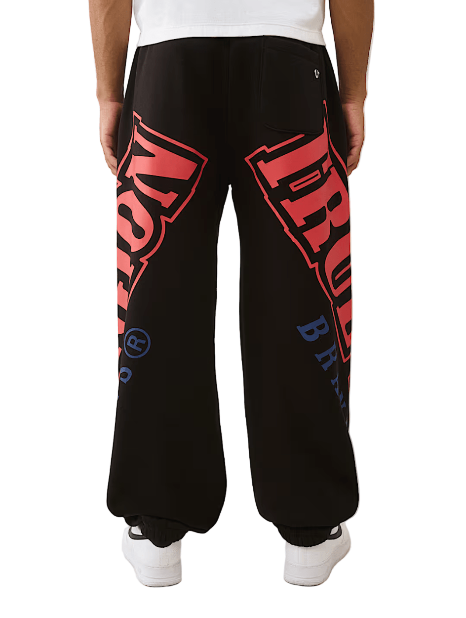 True Religion Arched Logo Baggy Jogger from On Time Fashions – Track Pants by True Religion, Birmingham AL’s 1 fashion store and premier destination for streetwear, suits, kids fashion, and big & tall