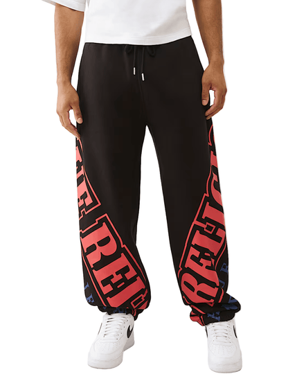 True Religion Arched Logo Baggy Jogger from On Time Fashions – Track Pants by True Religion, Birmingham AL’s 1 fashion store and premier destination for streetwear, suits, kids fashion, and big & tall