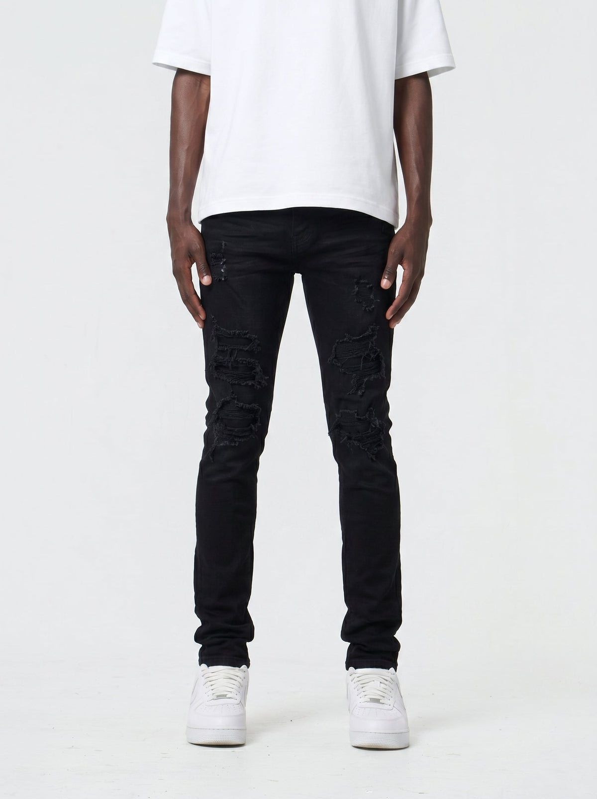 Waimea M5759 skinny fit jeans in Black with distressed rip-and-repair panels, front view on model