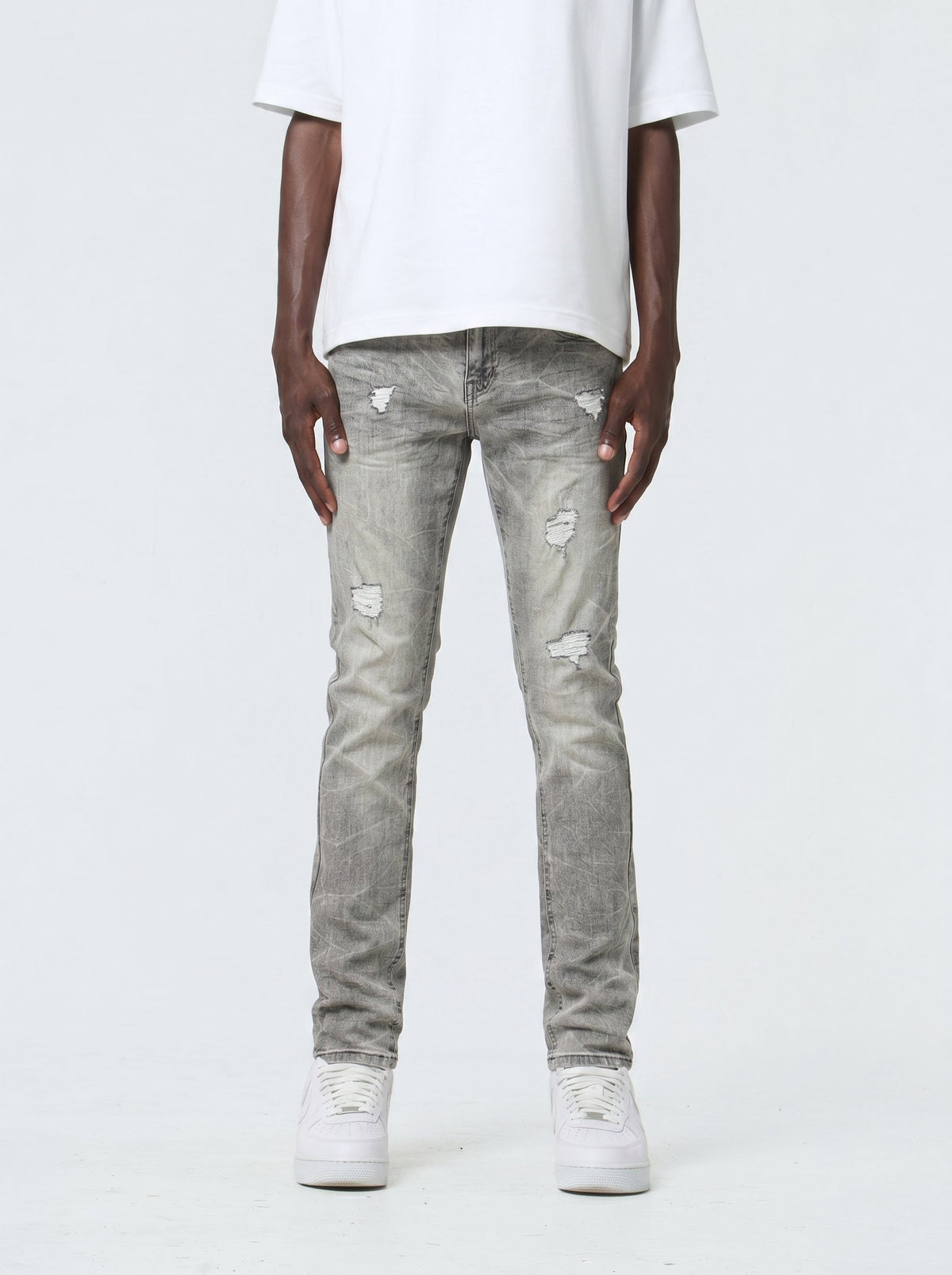 Waimea M8658 slim fit jeans in Antique Gray with rip-and-repair details, front view on model