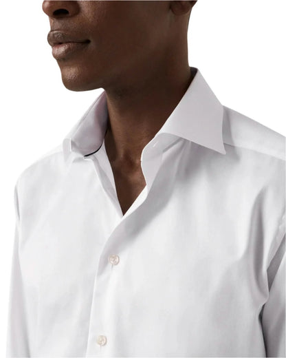 Close-up of a white shirt collar and front buttons.