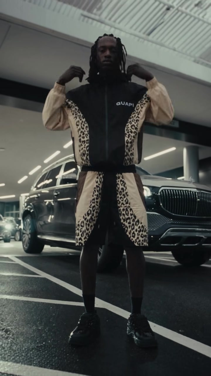 Model wearing the GUAPI Leo Nylon Track Set in Leopard, matching the stocked jacket and shorts.